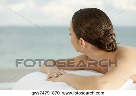 Close-up of a young woman lying on a massage table View Large Photo Image Stock Image - Close-up of a young woman lying on a massage table. Fotosearch