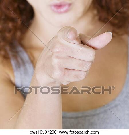 Close-up of a young woman pointing forward View Large Photo Image Stock Image - Close-up of a young woman pointing forward. Fotosearch