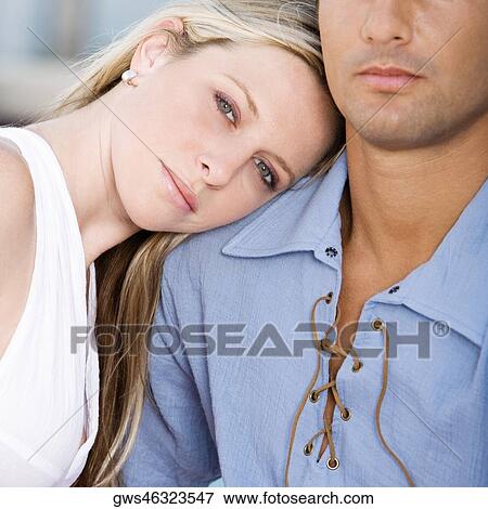 Close-up of a young woman resting her head on a mid adult man's shoulder View Large Photo Image Stock Photo - Close-up of a young woman resting her head on a mid adult man's shoulder. Fotosearch