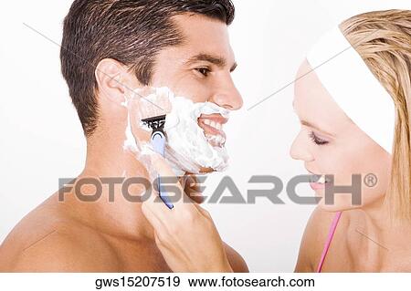 Close-up of a young woman shaving a mid adult man's face View Large Photo Image Stock Photo - Close-up of a young woman shaving a mid adult man's face. Fotosearch