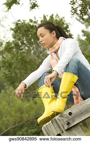 Close-up of a young woman sitting on a park bench View Large Photo Image Stock Photography - Close-up of a young woman sitting on a park bench. Fotosearch