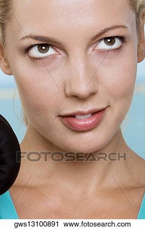 Close-up of a young woman smiling View Large Photo Image Stock Image - Close-up of a young woman smiling. Fotosearch
