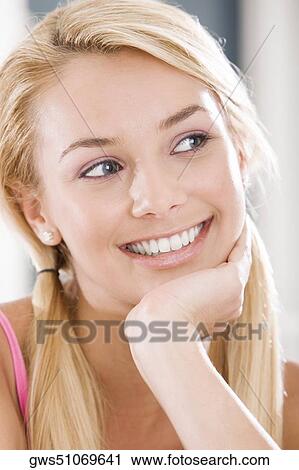 Close-up of a young woman smiling View Large Photo Image Stock Image - Close-up of a young woman smiling. Fotosearch