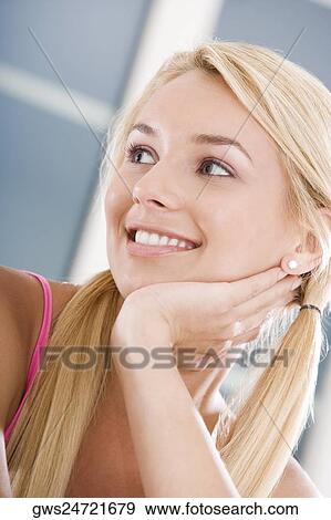 Close-up of a young woman smiling View Large Photo Image Stock Photo - Close-up of a young woman smiling. Fotosearch