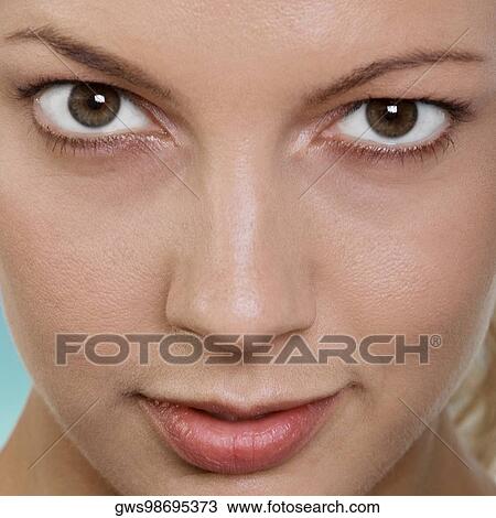 Close-up of a young woman staring View Large Photo Image Stock Image - Close-up of a young woman staring. Fotosearch