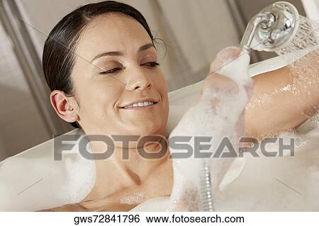 Close-up of a young woman taking a shower View Large Photo Image Stock Photograph - Close-up of a young woman taking a shower. Fotosearch