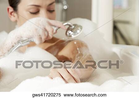 Stock Photography - Close-up of a young woman taking a shower. Fotosearch
