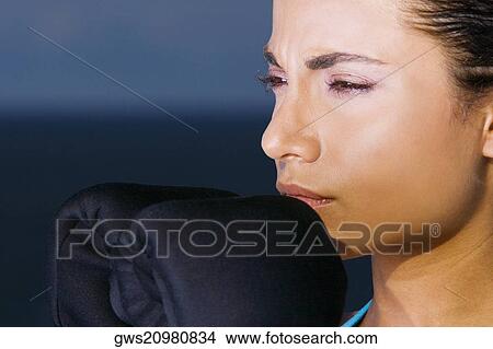Close-up of a young woman thinking View Large Photo Image Picture - Close-up of a young woman thinking. Fotosearch