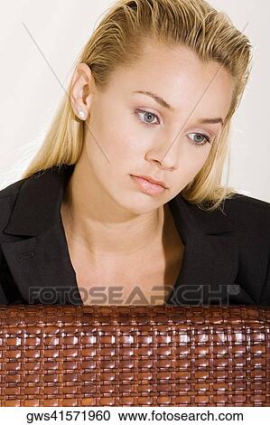 Close-up of a young woman thinking View Large Photo Image Stock Image - Close-up of a young woman thinking. Fotosearch