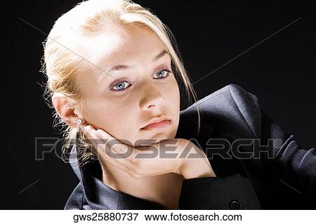 Close-up of a young woman thinking View Large Photo Image Stock Photo - Close-up of a young woman thinking. Fotosearch