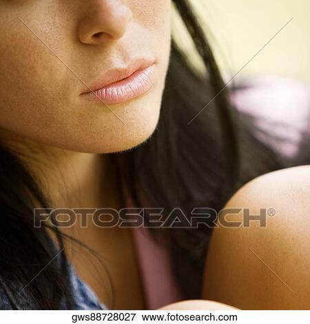 Close-up of a young woman thinking View Large Photo Image Stock Photo - Close-up of a young woman thinking. Fotosearch