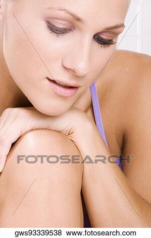 Close-up of a young woman thinking View Large Photo Image Stock Photo - Close-up of a young woman thinking. Fotosearch