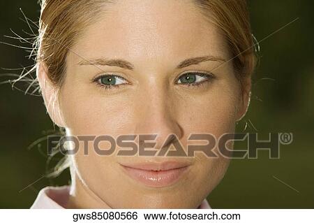 Close-up of a young woman thinking View Large Photo Image Stock Photograph - Close-up of a young woman thinking. Fotosearch