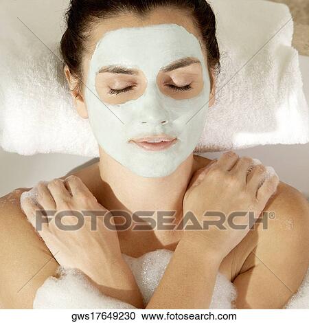 Close-up of a young woman wearing a facial mask in a bathtub View Large Photo Image Stock Image - Close-up of a young woman wearing a facial mask in a bathtub. Fotosearch
