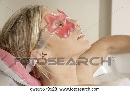 Close-up of a young woman wearing an eye mask View Large Photo Image Stock Photo - Close-up of a young woman wearing an eye mask. Fotosearch