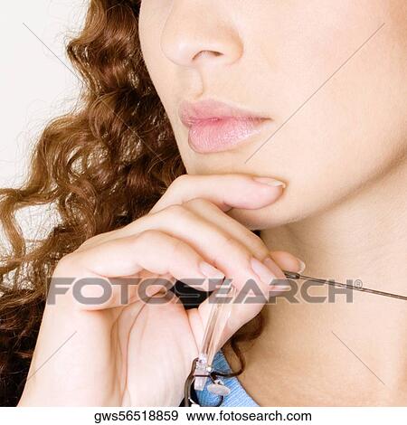 Close-up of a young woman with her hand on her chin View Large Photo Image Stock Photo - Close-up of a young woman with her hand on her chin. Fotosearch