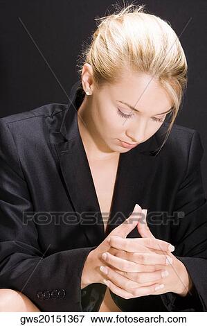 Close-up of a young woman with her hands clasped View Large Photo Image Stock Photo - Close-up of a young woman with her hands clasped. Fotosearch