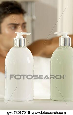 Stock Photograph - Close-up of bottles of shampoo and conditioner in the bathroom. Fotosearch