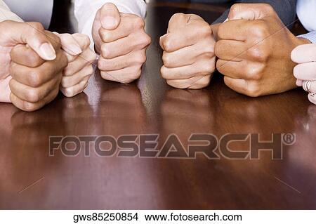 Close-up of human fists on the table View Large Photo Image Picture - Close-up of human fists on the table. Fotosearch