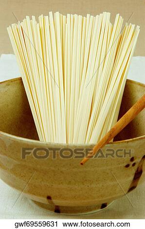 Close-up of raw spaghetti in a bowl View Large Photo Image Stock Image - Close-up of raw spaghetti in a bowl. Fotosearch