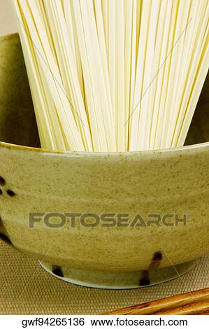 Close-up of raw spaghetti in a bowl View Large Photo Image Stock Photograph - Close-up of raw spaghetti in a bowl. Fotosearch