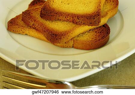 Close-up of slices of toast in a plate View Large Photo Image Stock Photograph - Close-up of slices of toast in a plate. Fotosearch
