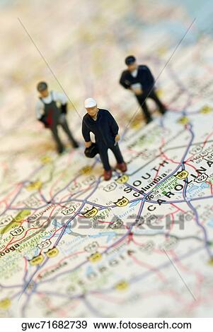 Close-up of the figurines of three construction workers on a map View Large Photo Image Stock Photo - Close-up of the figurines of three construction workers on a map. Fotosearch