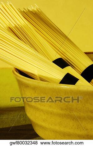 Close-up of three bundles of raw spaghetti View Large Photo Image Stock Photo - Close-up of three bundles of raw spaghetti. Fotosearch
