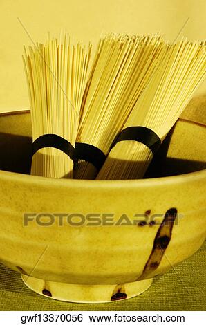 Close-up of three bundles of raw spaghetti View Large Photo Image Stock Photograph - Close-up of three bundles of raw spaghetti. Fotosearch