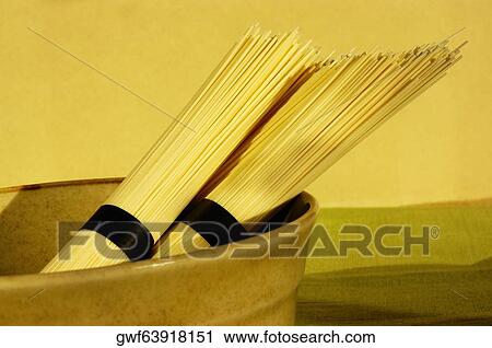 Close-up of two bundles of raw spaghetti View Large Photo Image Stock Image - Close-up of two bundles of raw spaghetti. Fotosearch