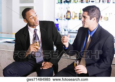 Close-up of two businessmen holding champagne flutes View Large Photo Image Stock Photography - Close-up of two businessmen holding champagne flutes. Fotosearch