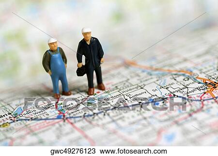 Close-up of two human figurines on a map View Large Photo Image Stock Image - Close-up of two human figurines on a map. Fotosearch