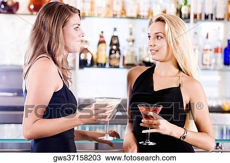 Close-up of two young women holding glasses of cocktail View Large Photo Image Stock Image - Close-up of two young women holding glasses of cocktail. Fotosearch