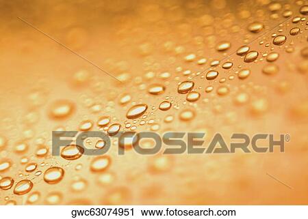 Stock Image - Close-up of water drops on a surface. Fotosearch