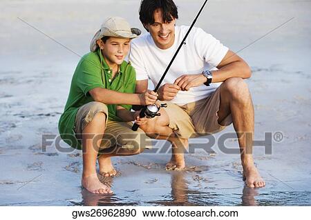 Father and his son fishing on the beach View Large Photo Image Stock Image - Father and his son fishing on the beach. Fotosearch