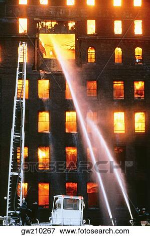 Fire fighters spraying water at a burning factory, Baltimore, Maryland, USA View Large Photo Image Stock Photo - Fire fighters spraying water at a burning factory, Baltimore, Maryland, USA. Fotosearch