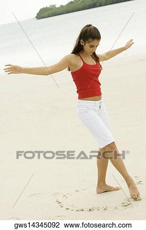 Girl drawing in sand with her toe View Large Photo Image Stock Image - Girl drawing in sand with her toe. Fotosearch