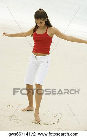 Girl drawing in sand with her toe View Large Photo Image Stock Image - Girl drawing in sand with her toe. Fotosearch