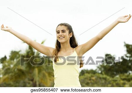 Girl standing with her arms outstretched View Large Photo Image Stock Photo - Girl standing with her arms outstretched. Fotosearch