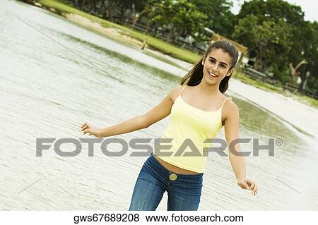Girl wading in water on the beach View Large Photo Image Stock Photo - Girl wading in water on the beach. Fotosearch