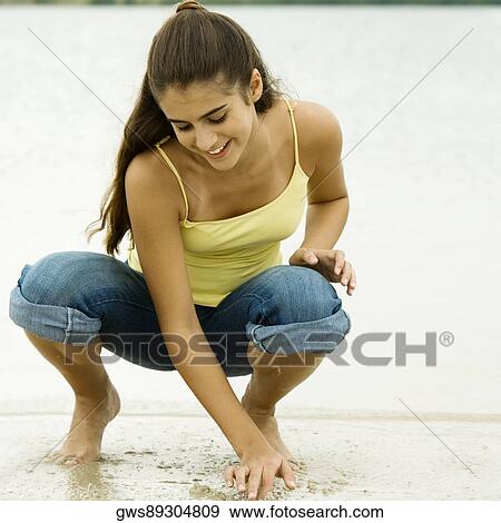 Girl writing in sand with her finger View Large Photo Image Stock Photo - Girl writing in sand with her finger. Fotosearch