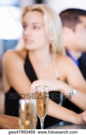Glasses of champagne at a bar counter View Large Photo Image Stock Photo - Glasses of champagne at a bar counter. Fotosearch