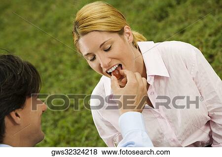 High angle view of a businessman feeding a cherry to a businesswoman View Large Photo Image Stock Photo - High angle view of a businessman feeding a cherry to a businesswoman. Fotosearch