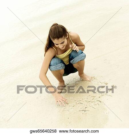 High angle view of a girl playing tic-tac-toe on the beach View Large Photo Image Stock Photo - High angle view of a girl playing tic-tac-toe on the beach. Fotosearch