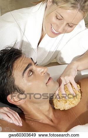 Stock Photo - High angle view of a massage therapist talking to a young man. Fotosearch