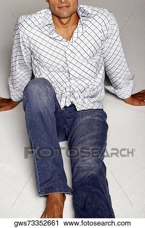 High angle view of a mid adult man sitting on the floor View Large Photo Image Stock Image - High angle view of a mid adult man sitting on the floor. Fotosearch