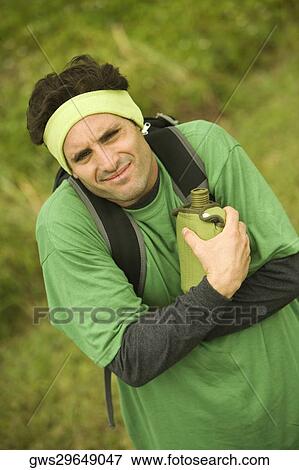 High angle view of a mid adult man holding a water bottle View Large Photo Image Stock Photo - High angle view of a mid adult man holding a water bottle. Fotosearch