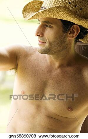 Stock Photo - High angle view of a mid adult man wearing a cowboy hat. Fotosearch