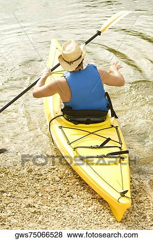 High angle view of a mid adult man sitting in a kayak View Large Photo Image Stock Photo - High angle view of a mid adult man sitting in a kayak. Fotosearch