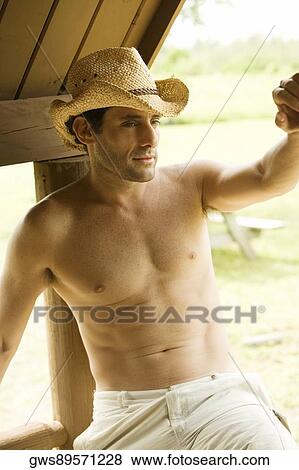 High angle view of a mid adult man sitting on a railing View Large Photo Image Stock Photo - High angle view of a mid adult man sitting on a railing. Fotosearch